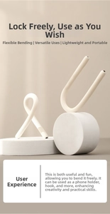 Close-up of flexible beige multipurpose S-hook on a minimalist geometric stone stand
