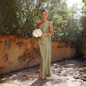 Detail of elegant sage green satin dress showing the one-shoulder design and silky texture