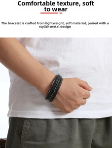 Detailed view of handmade multi-layer black woven leather bracelet on male model wrist