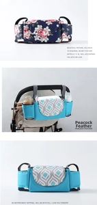 Detail view of universal stroller organizer with peacock feather print and bottle holders