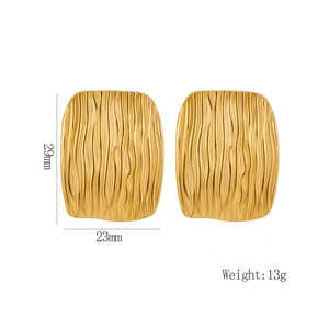 Detail of gold rectangular earrings with wave texture, measuring 29mm by 23mm