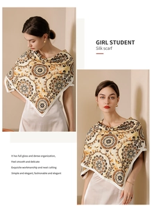 Detail view of baroque silk scarf styled as a shawl featuring golden mandala prints