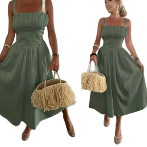 Detail of olive green strapless dress with pleated chest design and flowing hem