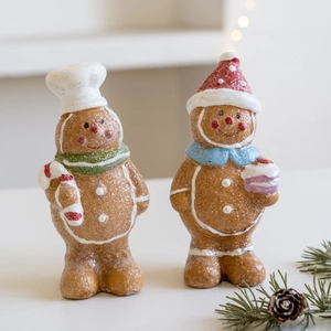 Set of two glittery resin gingerbread man ornaments with chef hat and Christmas accessories
