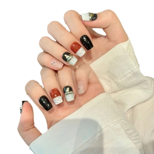 Handmade press-on nails featuring dark hand-painted marble, gold foil, and metal relief lines