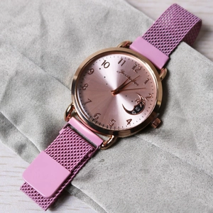 Milanese pink mesh strap watch with rose gold case and moon star dial detail