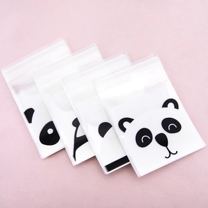 Detail view of four transparent self-adhesive cookie bags with panda cartoon prints