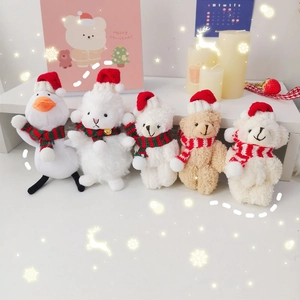 Plush Christmas bear and duck keychain charms with red hats and striped scarves