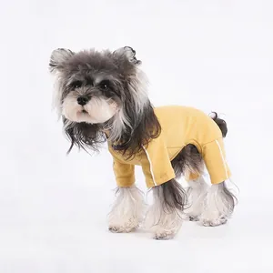 Bright yellow four-legged dog bodysuit with white stripes on a Schnauzer dog