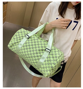 Fashionable green checkered large capacity travel duffel bag carried by model