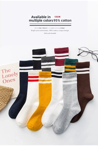 Flat lay of colorful ribbed cotton crew socks in ten shades with classic varsity stripes