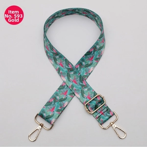 Close-up of adjustable strap featuring pink flamingo print and gold metal hardware