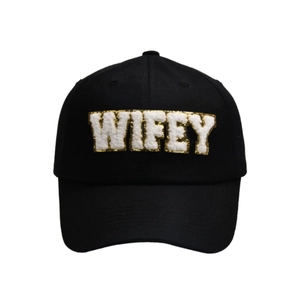 Detail of WIFEY letter patches with plush white fabric and gold sequin embroidery on hat