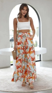 Close-up of white cropped tank top and high-waisted wide-leg floral pants for women