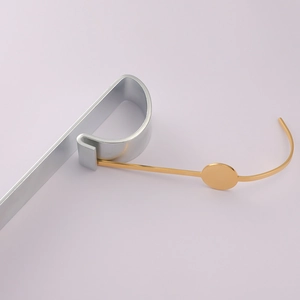 Detail view of mirror polished gold stainless steel bar accessory on display stand