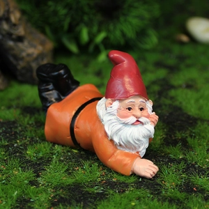 Charming garden gnome resin ornament with red hat lying in moss for landscape decor