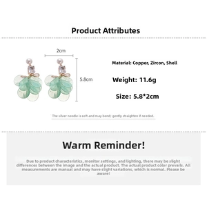 Detailed view of long earrings showing 5.8cm length, pearl and shell flower texture