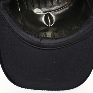 Close-up of a black baseball cap brim featuring multi-row stitching and textured fabric