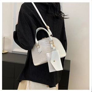 White crocodile pattern shell handbag with gold hardware and small matching coin purse