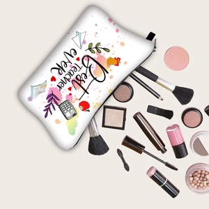 White zipper makeup bag with Best Teacher Ever print surrounded by beauty accessories