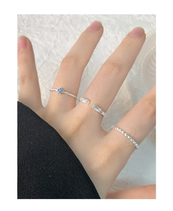 Detailed view of S925 silver ring set with blue floral and square zircon accents on hand
