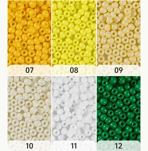 Detail view of 4mm glass seed beads in yellow, cream and white colors for DIY jewelry