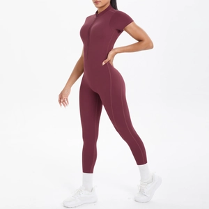 Front view of burgundy short sleeve yoga bodysuit with stand collar and zipper detail