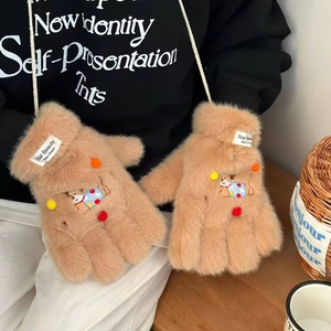 Detail of camel plush neck-strap gloves with cute puppy embroidery and colorful pom-poms