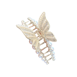 Elegant gold butterfly hair claw clip with pearls and rhinestones on a white background