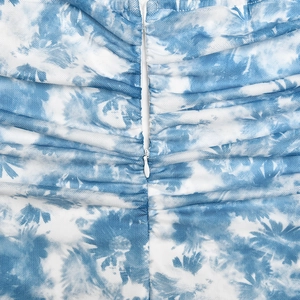 Detail of blue tie-dye mesh dress showing the concealed zipper and pleated texture