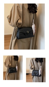 Chic black litchi texture shoulder bag with silk scarf detail worn with khaki coat