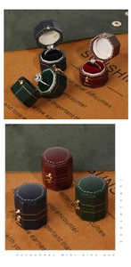 Detail of octagonal mini leather jewelry box with metal clasp and velvet interior