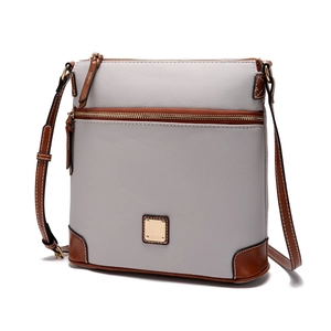 Close-up of grey litchi grain leather crossbody bag with brown trim and gold hardware