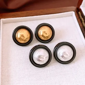 Retro round button earrings with hammered texture and face relief in gold and silver
