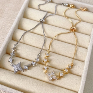 Detail of gold and silver adjustable star bracelets with cubic zirconia in a jewelry box