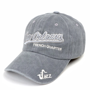 Detail of New Orleans jazz embroidery and washed cotton texture on grey baseball cap