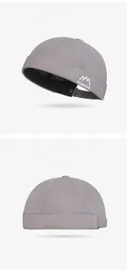 Detailed embroidery of mountain peak and FASHION text on a gray brimless docker hat