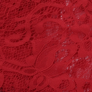 Macro detail of red lace fabric with intricate floral patterns and hollow-out texture