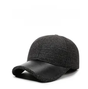 Close-up of wool texture and black leather brim on warm winter baseball cap