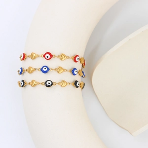 Three-piece Evil Eye and heart charm bracelets in gold finish with color enamel beads