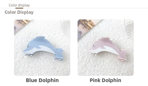 Detail display of blue and pink dolphin hair claws with sparkling star rhinestones