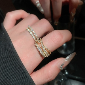 Close-up of sparkling cubic zirconia and pearl rings set in a luxurious gold finish