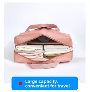 Detailed interior view of a pink large capacity travel bag showing organized clothing storage