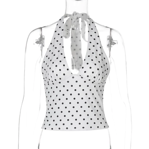 Detail view of polka dot halter top featuring a deep V-neck and backless tie-up design