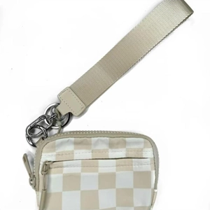 Macro detail of the checkered pattern card holder with a beige wrist strap and metal zipper