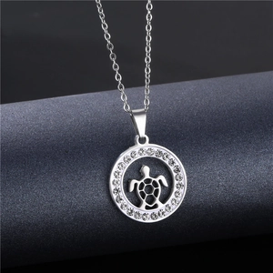 Close-up of silver sea turtle pendant necklace with sparkling white pavé crystals