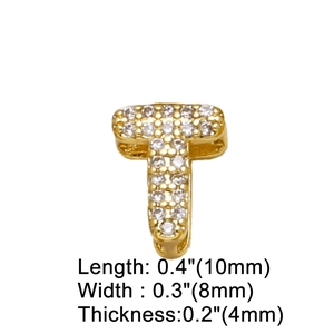 Macro detail of gold letter T pendant with zircon inlays and precise measurements