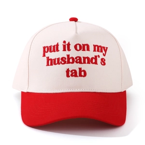 Detail of red and white vintage baseball cap featuring retro husband's tab embroidery