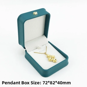 Detail view of green PU leather pendant box with gold crown and 72x82x40MM dimensions