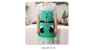 Close-up of green Christmas elf apron featuring black belt print and white pompom detail
